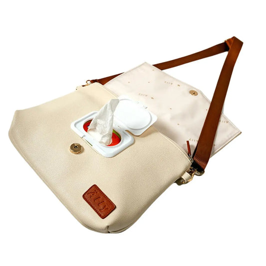 A white handbag with a tissue inside, featuring a long strap and a wrist strap for versatile carrying options. Lightweight and designed in Europe, with a removable wet wipes pocket.