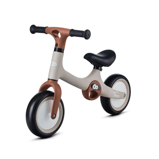 A close-up of the TOVE balance bike showcasing its puncture-resistant foam wheels, adjustable seat, and lightweight construction with two carry handles for easy transport.