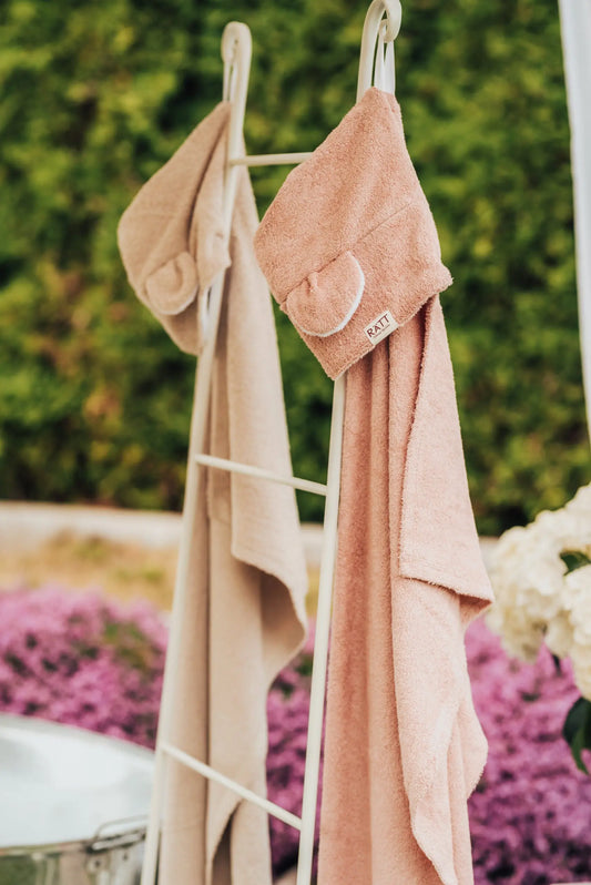 A hooded baby bath towel featuring charming TEDDY ears, made of OEKO-TEX certified bamboo terry material. Ideal for infants, hand-made in Europe for superior quality. Ultra-soft, cozy, and gentle on delicate skin.