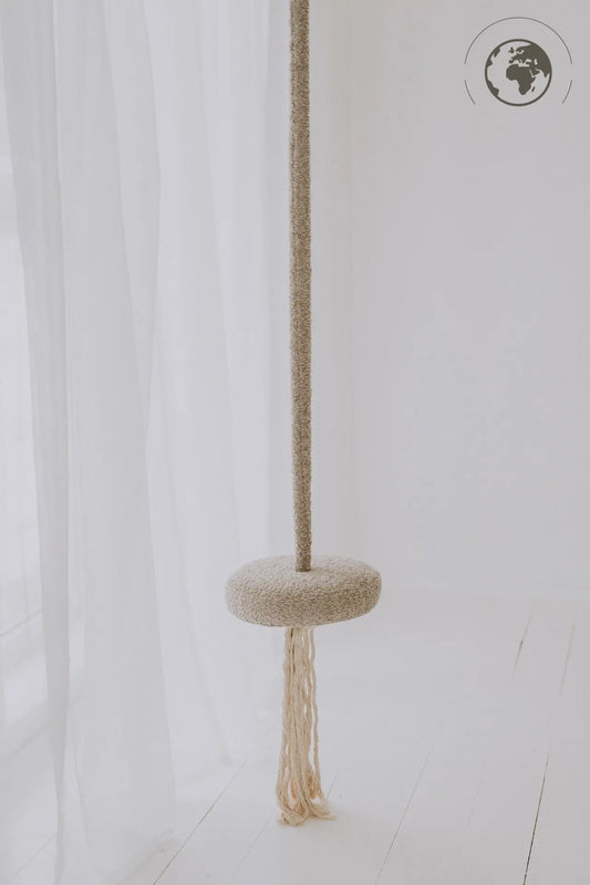 HopOn Swing - Bouclé Sand, a round swing seat with cotton rope, suitable for indoor use. Supports physical development, OEKO-TEX certified materials, 100 kg load capacity.