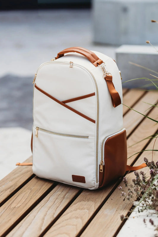 A white and brown backpack with multiple pockets, laptop and baby food compartments, stroller straps, and a waterproof changing mat. Large Diaper Backpack – Cappuccino by Ally Scandic, designed for style and functionality.