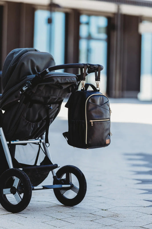 A compact Espresso Diaper Backpack with thoughtful organization, sturdy design, and stroller straps for hands-free convenience. Ideal for stylish, on-the-go parents seeking practicality and style.