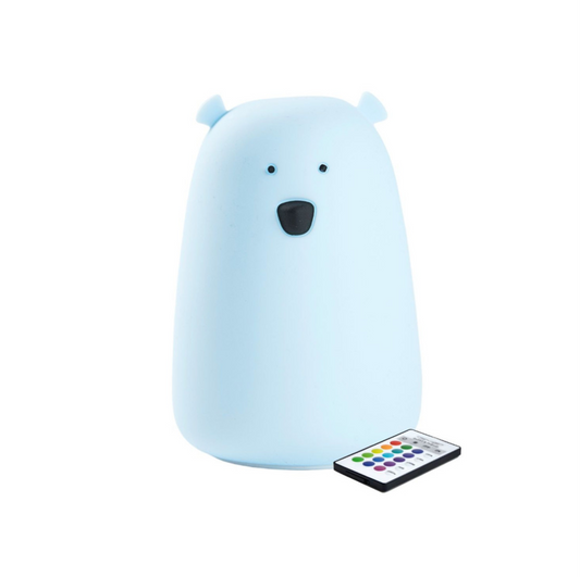 A blue silicone lamp shaped like a teddy bear with a remote control. Soft, touchable, and safe for children. Features 7 colors, auto-off, and remote functions.
