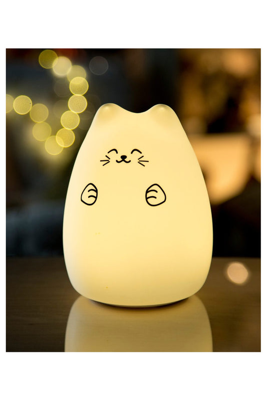 A white silicone Lucky Cat night lamp, shaped like a cat with a drawing, emits warm light. Features soft touch, 7-color glow, touch activation, and 12-hour working time. Dimensions: 14.3 x 10.5 x 10.5 cm.