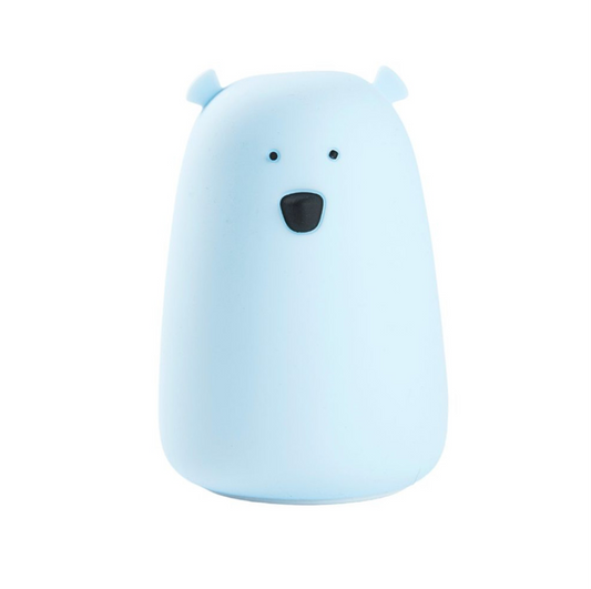 A charming white silicone lamp in the shape of a teddy bear with a black nose and protruding ears. Soft, touch-responsive, and portable for bedtime comfort and play.