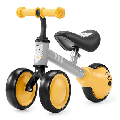 A yellow and black balance bike with a kitten print, adjustable saddle, rubber handles, ball-bearing rear wheel, and a strong steel frame for safe and fun play.