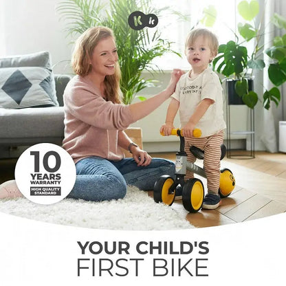 A woman and child with a balance bike, CUTIE - Yellow. Child-friendly features like adjustable saddle, rubber handles, and sturdy frame for safe play and balance learning.