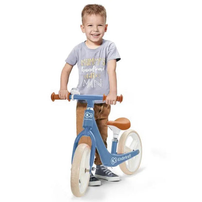 A child on the FLY PLUS balance bike with puncture-proof foam wheels, adjustable saddle, and limited turning handlebar for safe, fun rides.