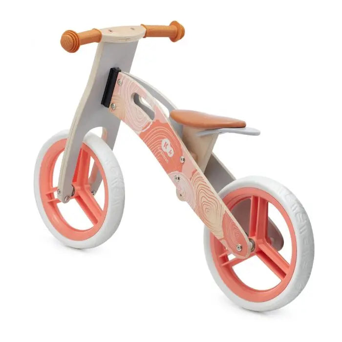 A pink and white tricycle with 12-inch EVA foam wheels, birch wood frame, and anti-slip rubber grips. RUNNER balance bike for kids aged 3 and up, promoting balance and motor skills development.