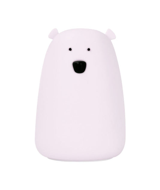 A white silicone lamp shaped like a bear with black eyes and a round belly, emitting soft, soothing light for bedtime routines.