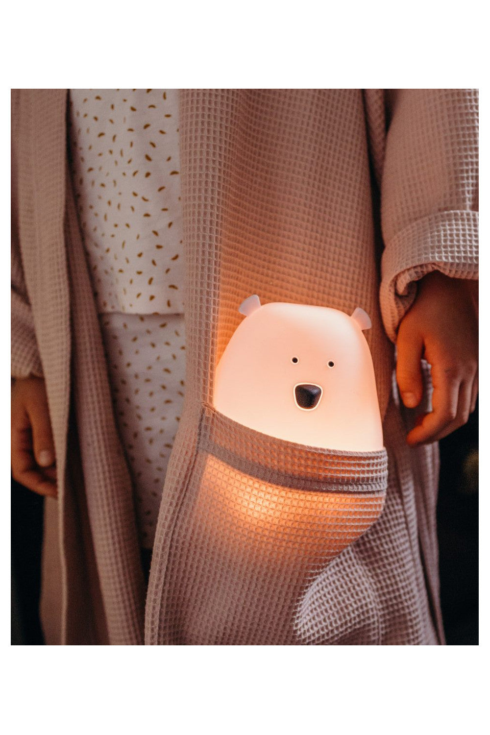 A person in a robe with a light in the pocket, close-up of a bear-faced light, and a hand near a black object. Big Bear Silicone Lamp with Remote - Pink, soft, touchable, 7-color glow, remote-controlled, safe silicone, awards.