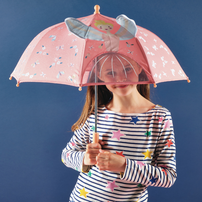 Girl holding the Color Changing 3D Umbrella - Enchanted, which transforms in rain with underwater motifs; features a clear panel and Velcro fastener.