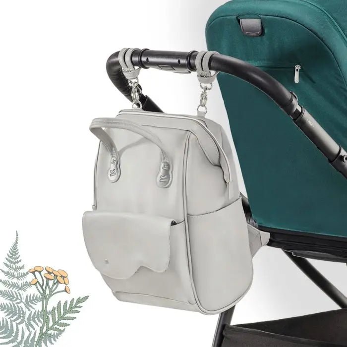 Diaper Backpack Treasureback: A versatile backpack with 9 pockets, thermal and wet clothes compartments, and stroller attachment capability. Stylish, spacious, and ideal for outings.