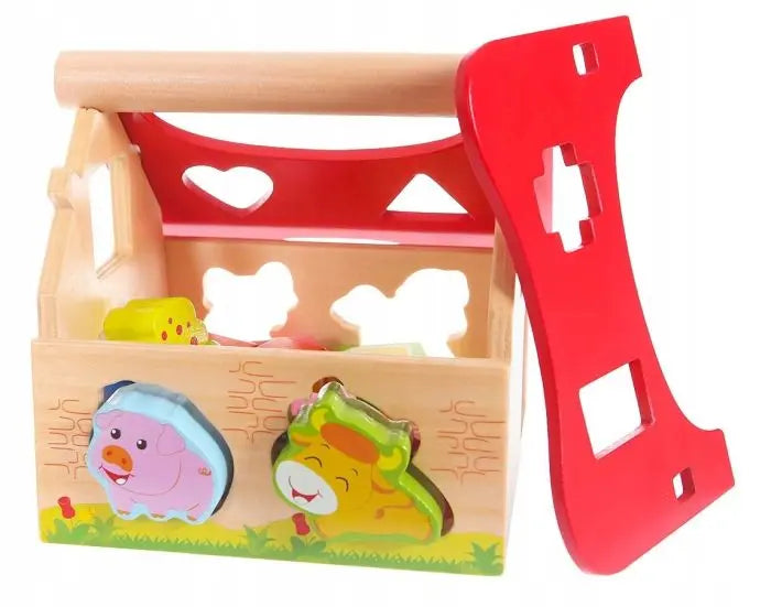 Wooden Farmhouse Shape Sorter with Animals, a compact toy box with a red handle, designed for educational fun and coordination development in young children.