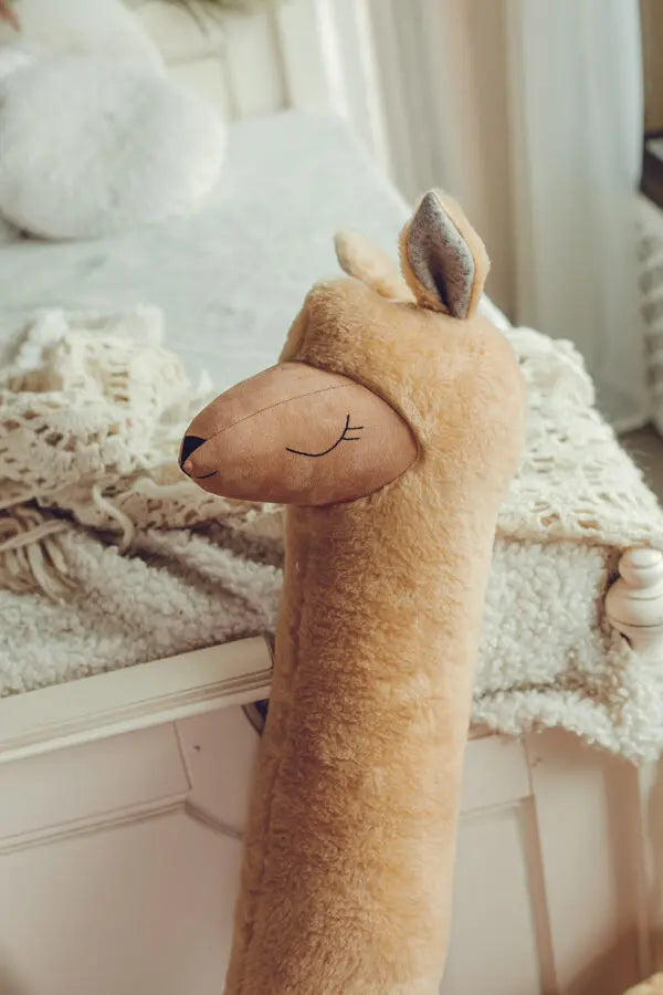 A handmade Giant Plush Toy Alpaca in Rust, a versatile companion doubling as a cozy pillow or playful playmate. Generously sized, super soft vegan fur, eco-friendly materials.