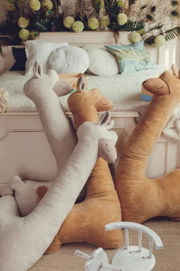 A group of Giant Plush Toy Alpacas in Rust, handmade with super soft vegan fur, perfect for cuddles and playtime. Ideal decor for a child's room.