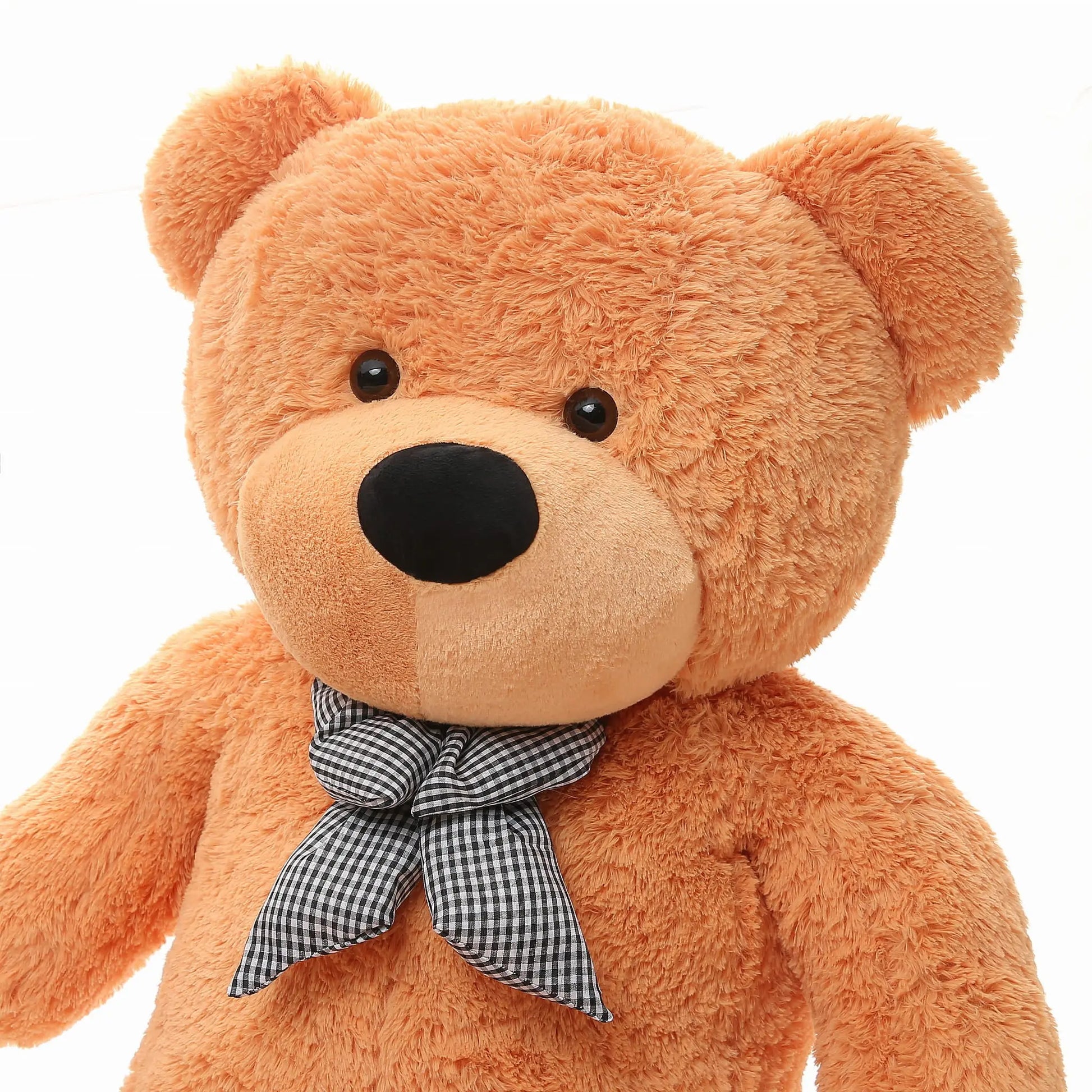 A close-up of a Giant Teddy Bear - 180 cm, featuring soft fur and a checkered bow. Ideal for hugging, washable, and EU safety certified. Perfect gift for joyful cuddling moments.