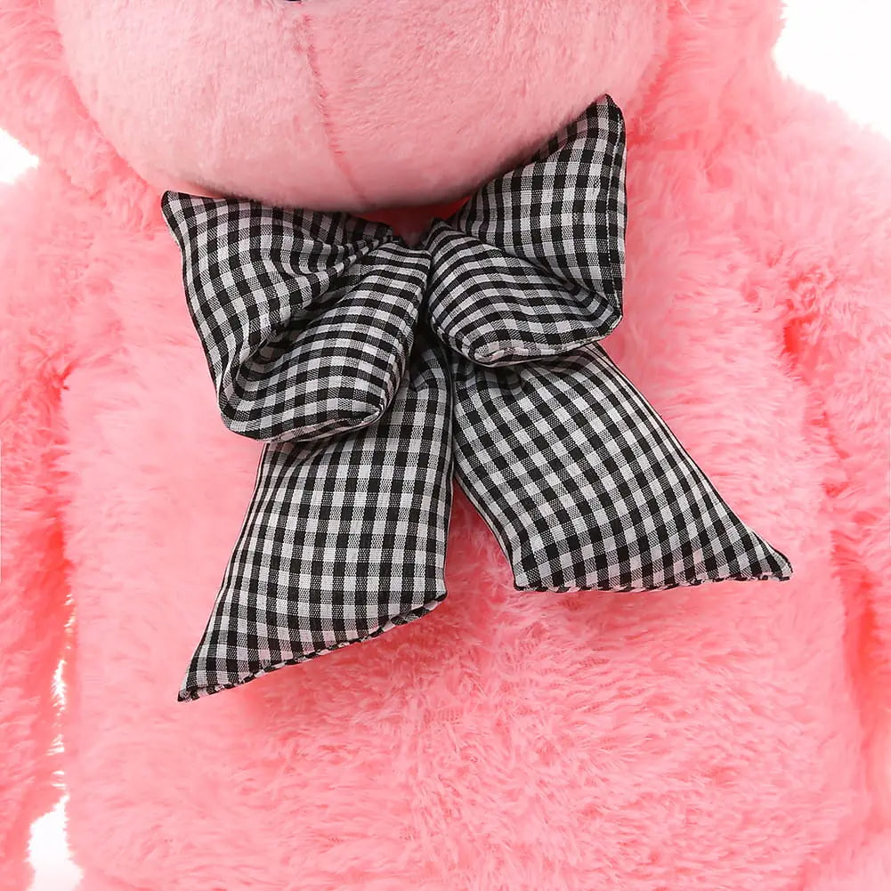 A close-up of a 180 cm Giant Teddy bear with soft pink fur and a black and white bow, embodying quality and safety for hugging.