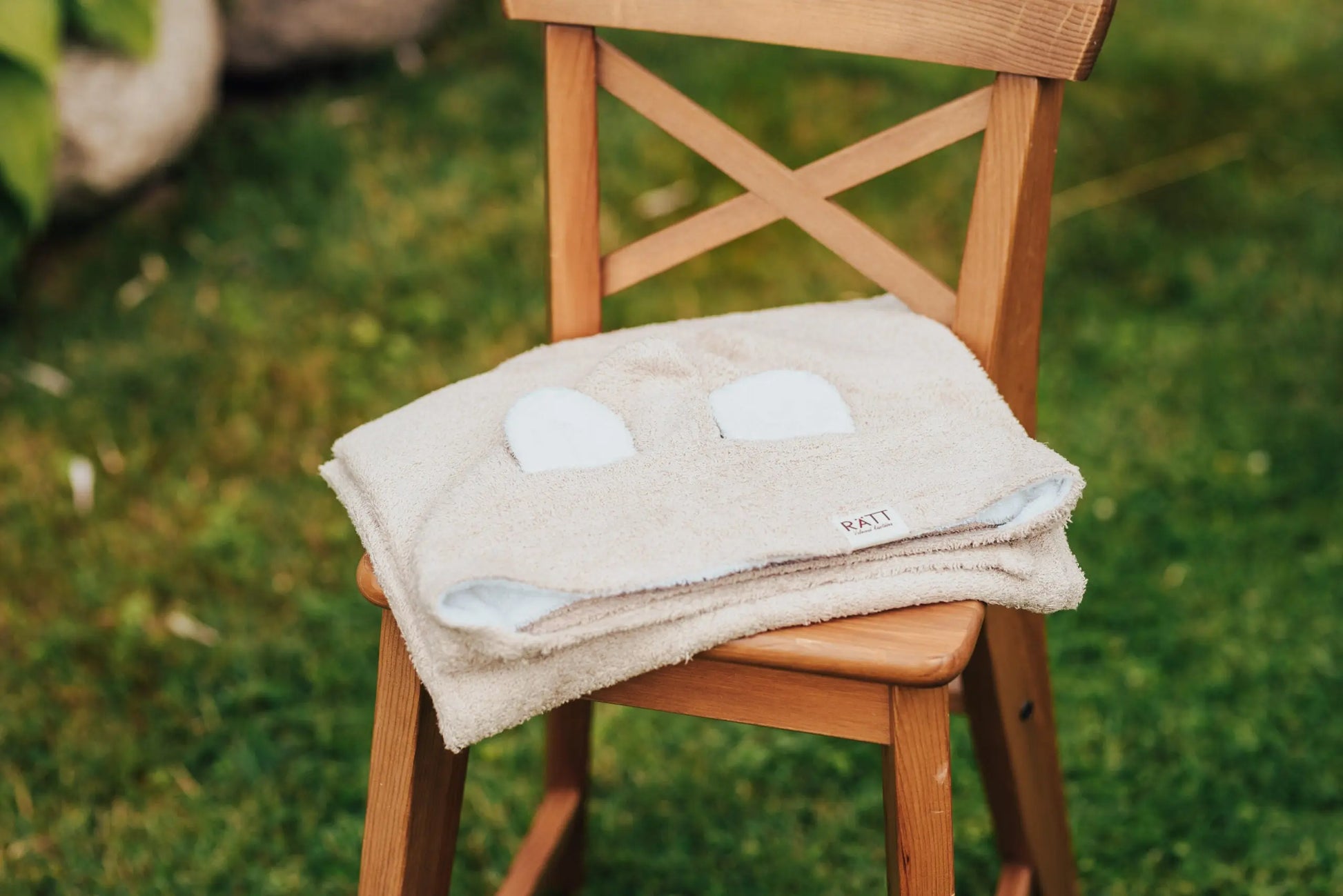 A white baby bath towel with hood featuring cute RABBIT ears, made from bamboo terry for delicate baby skin. Ideal christening gift, hand-made in Europe, machine washable at 30°C.