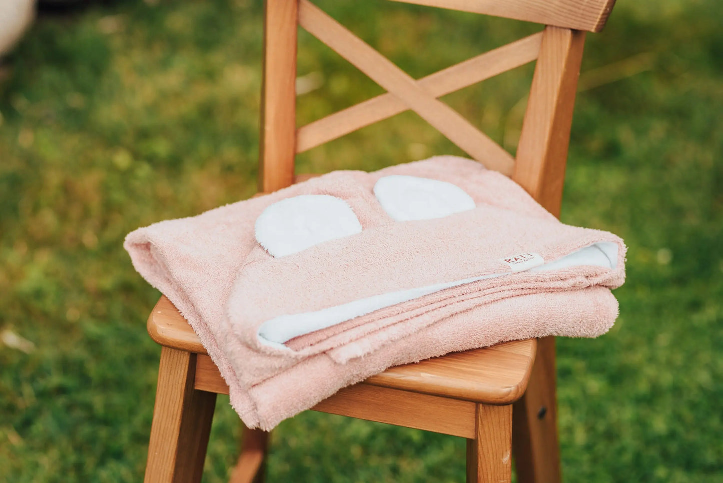 A hooded baby bath towel featuring RABBIT ears, made from bamboo terry for gentle skin care. Ideal christening gift with charming design for babies' first year.