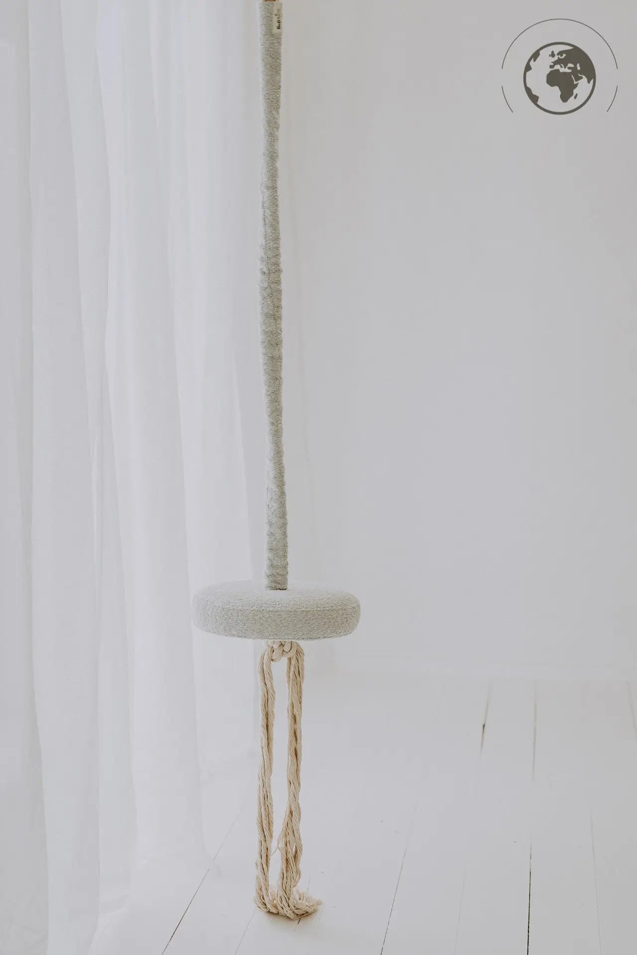 HopOn Swing - Bouclé Ice Grey: A white swing seat with cotton rope, suitable for indoor use. OEKO-TEX certified fabric and rope, supporting physical development and joy of swinging.