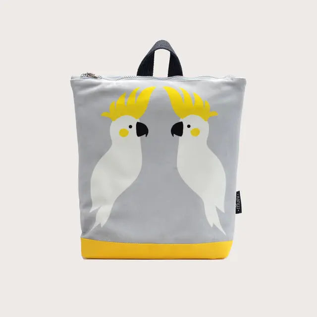 Kids backpack - Cockatoo: Grey and yellow bag with white bird design, velvet top, waterproof polyester bottom, beige shoulder straps, zipper closure, 2 slip pockets. Ideal for 4-10-year-olds.