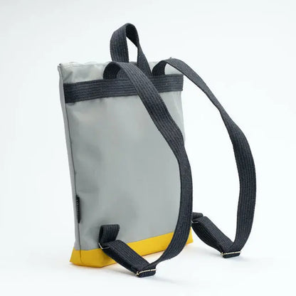 A large kids backpack featuring a grey and yellow design with a Cockatoo motif. Lightweight with adjustable beige straps, velvet top, waterproof polyester bottom, and orange lining. Dimensions: 38cm x 34cm.