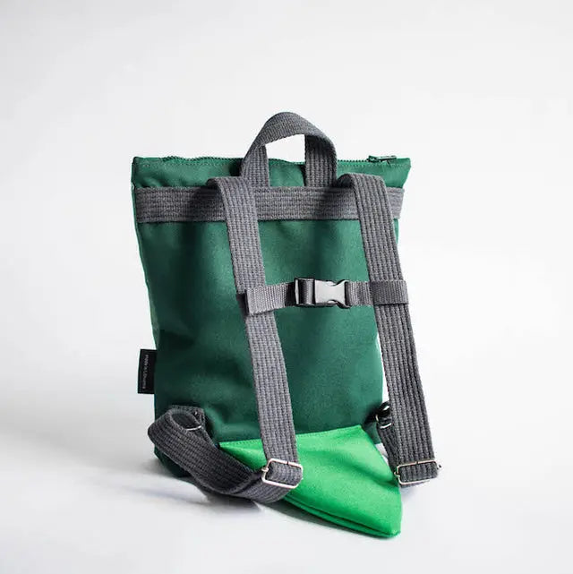 A toddler-friendly Crocodile-themed backpack for 2-6-year-olds. Green and grey with beige shoulder straps, velvet top, waterproof polyester bottom, and two inside slip pockets.