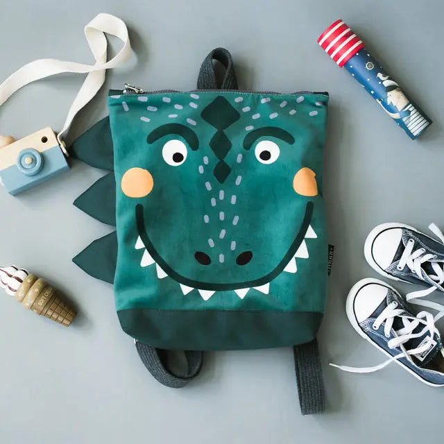 Kids backpack featuring a prehistoric Dino-rrific DINOSAUR design, ideal for outdoor adventures. Velvet top with dinosaur print, waterproof bottom, adjustable straps, and zipper closure. Sizes: Small (29x26 cm), Large (35x30 cm).