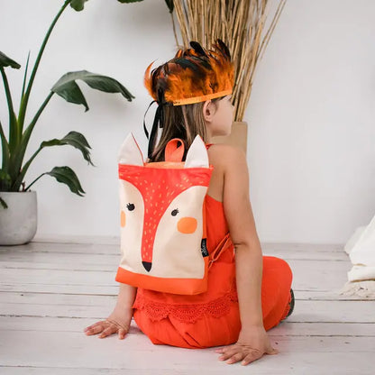 A girl wearing a fox backpack, embodying the Kids backpack - Fox. Velvet top with a Fox design, waterproof polyester bottom, adjustable straps, and zipper closure. Ideal for outdoor adventures.