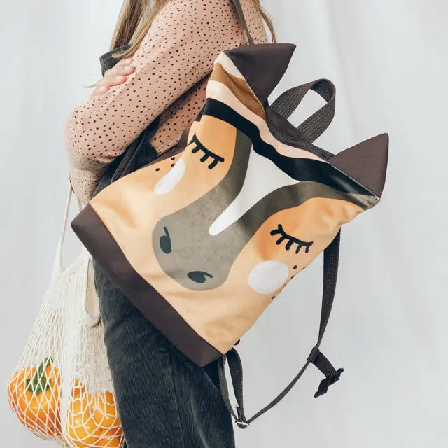 A playful HORSE backpack for kids, featuring a velvet top with a painted Horse design and waterproof orange polyester bottom. Adjustable beige shoulder straps, zipper closure, and two inside slip pockets.