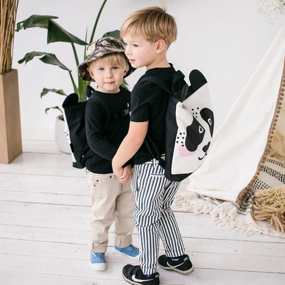 Kids backpack - Panda displayed outdoors, worn by children, features a velvet fabric with a panda design, adjustable straps, and durable polyester bottom.