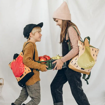 Kids backpack featuring a boy and girl holding a basket of fruit, ideal for young explorers. PEAR backpack with velvet top, waterproof bottom, adjustable straps, and ample storage for snacks and essentials.