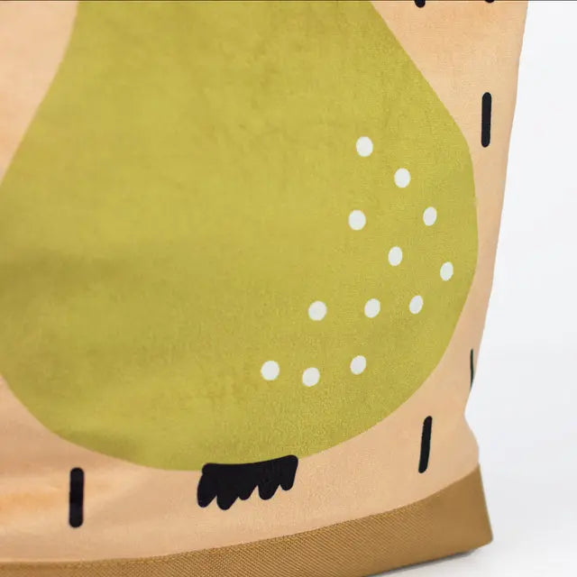 A close-up of a kids backpack featuring a pear motif. Made of velvet and waterproof polyester, with adjustable beige shoulder straps and a zipper closure. Ideal for young explorers aged 4-10.