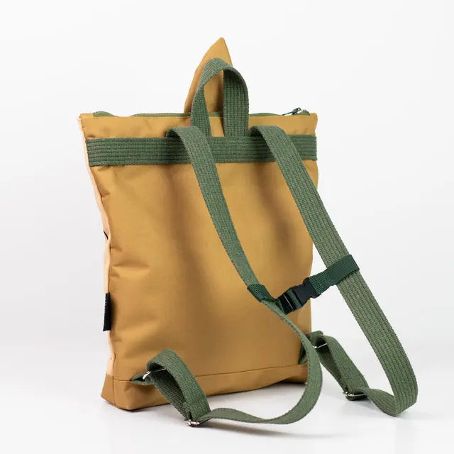 A tan and green kids backpack featuring a pear motif. Ideal for young explorers, with velvet and waterproof polyester materials, adjustable shoulder straps, and zipper closure. Dimensions: 35cm height, 30cm width.