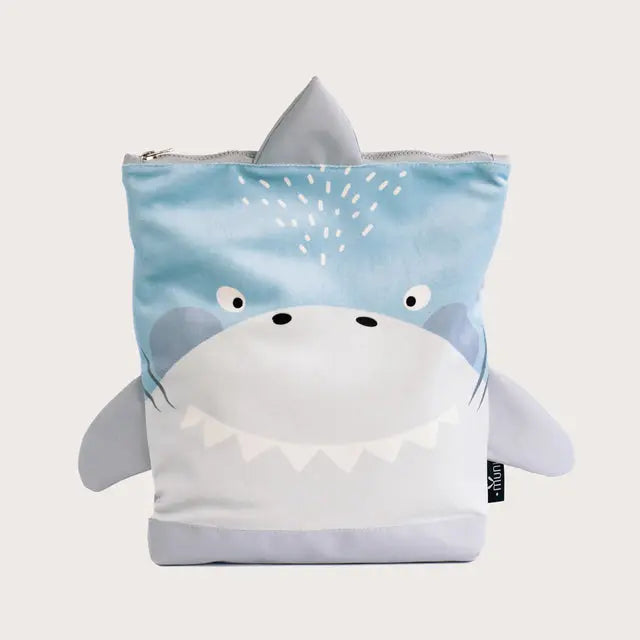 A shark-shaped kids backpack in blue and white, featuring a cartoon plush design. Made of velvet and waterproof polyester, with adjustable straps and zipper closure. Dimensions vary for different age groups.