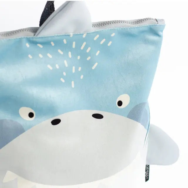 A close-up of a SHARK backpack, featuring a shark-inspired design. Made of velvet fabric with a waterproof polyester bottom. Available in small and large sizes for kids aged 2-10.