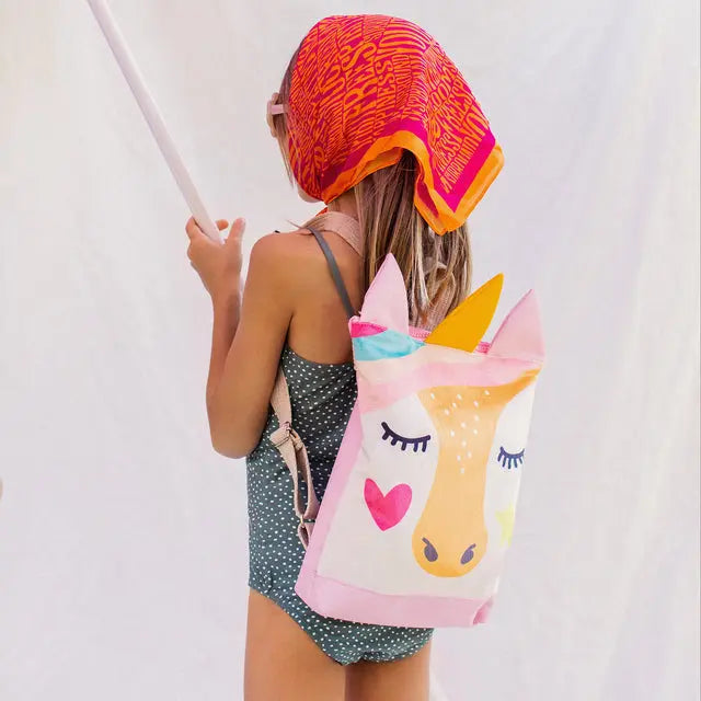 A girl with a unicorn-themed backpack, velvet top, and waterproof pink bottom. Roomy, with adjustable straps, ideal for kids aged 3-9 on outings.