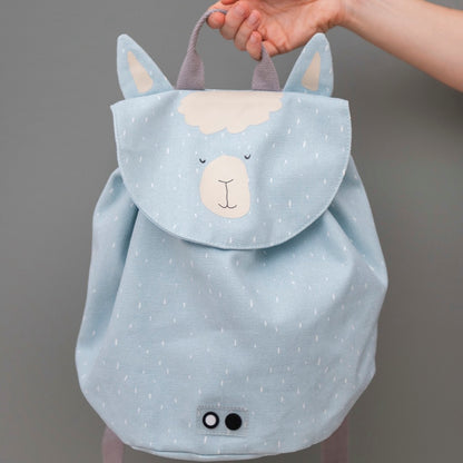 A hand holding a light blue mini drawstring backpack featuring Mr Alpaca design. Water repellent, washable, 100% cotton material, perfect for ages 3+, 5L capacity.