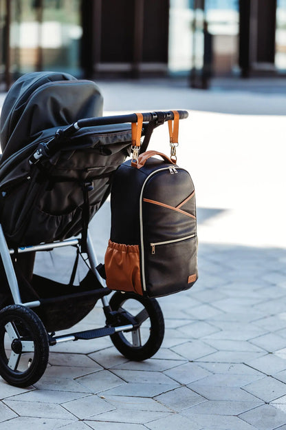 A stylish Large Diaper Backpack in Black Coffee, featuring 16 pockets, laptop and baby food compartments, stroller straps, and a waterproof changing mat. Designed for convenience and style by Ally Scandic.