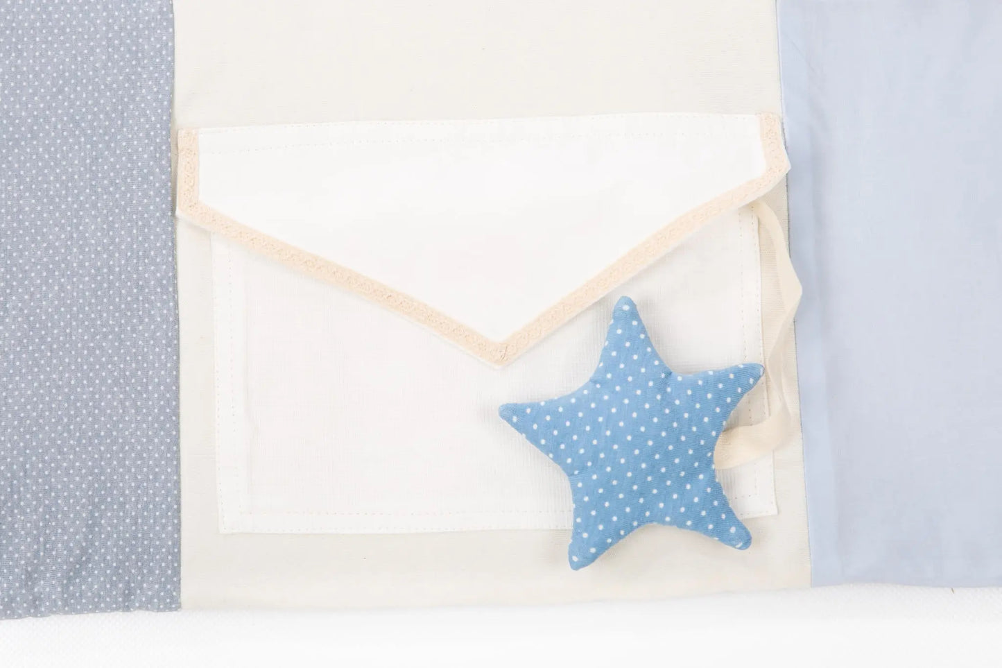 Handmade baby activity mat with blue star pillow and fabric, includes activity arches and stimulating toys for sensory exploration.