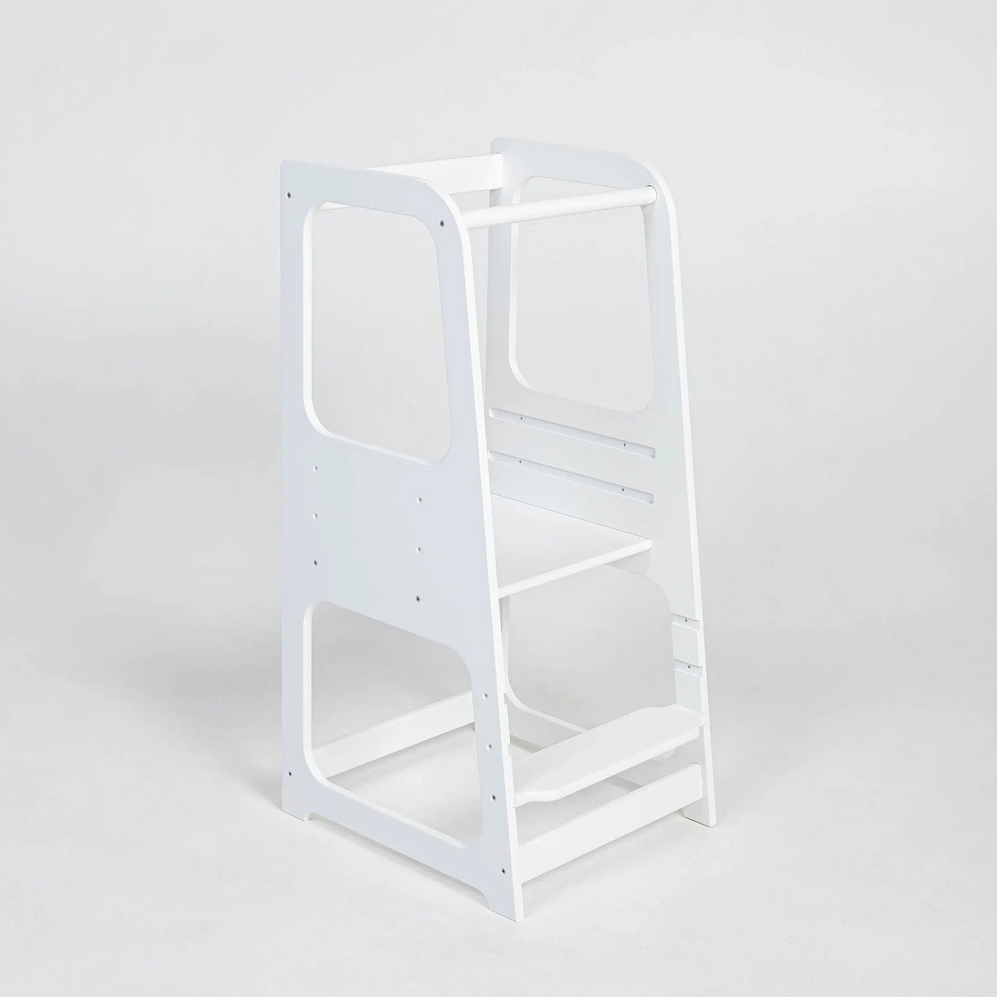 A Montessori Learning Tower Step Stool for Kids, featuring a white ladder with shelves and a chair, designed for safe and independent kitchen exploration by young learners.