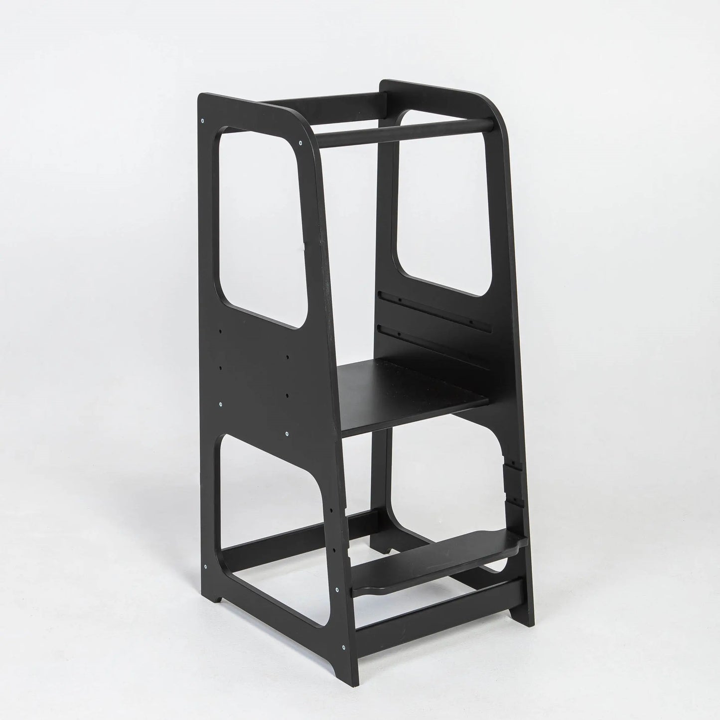 A black chair with a shelf, ideal for young learners and chefs, the Montessori Learning Tower Step Stool for Kids promotes independence and safe exploration in the kitchen.