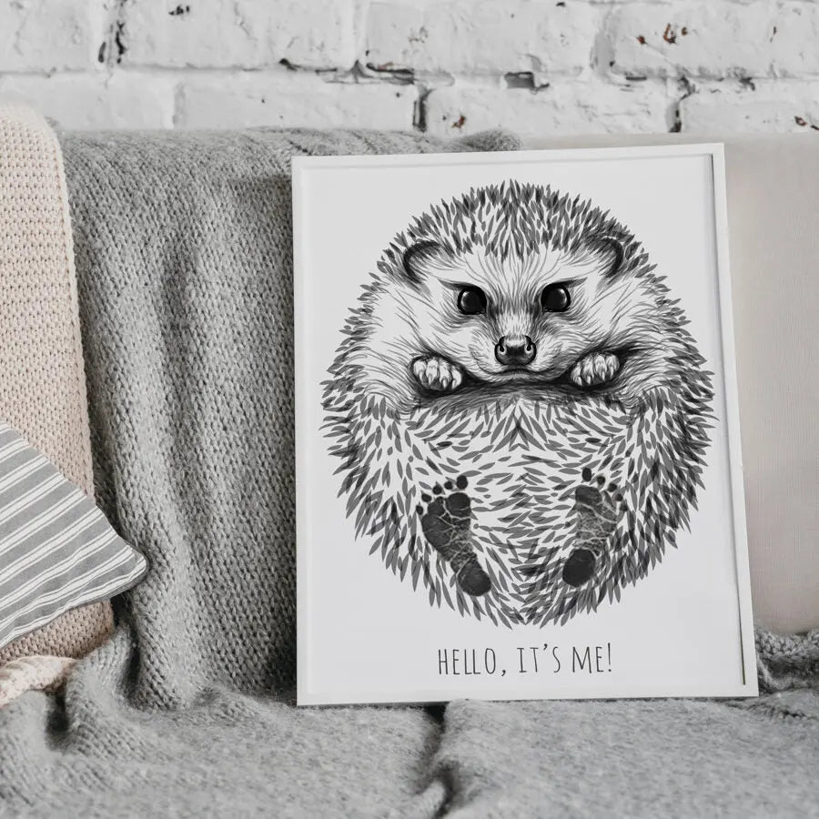 Hand-drawn baby hedgehog footprint kit with two A3 drawings, white frame, and baby-safe inkpad. Ideal for capturing little feet as a cherished keepsake.