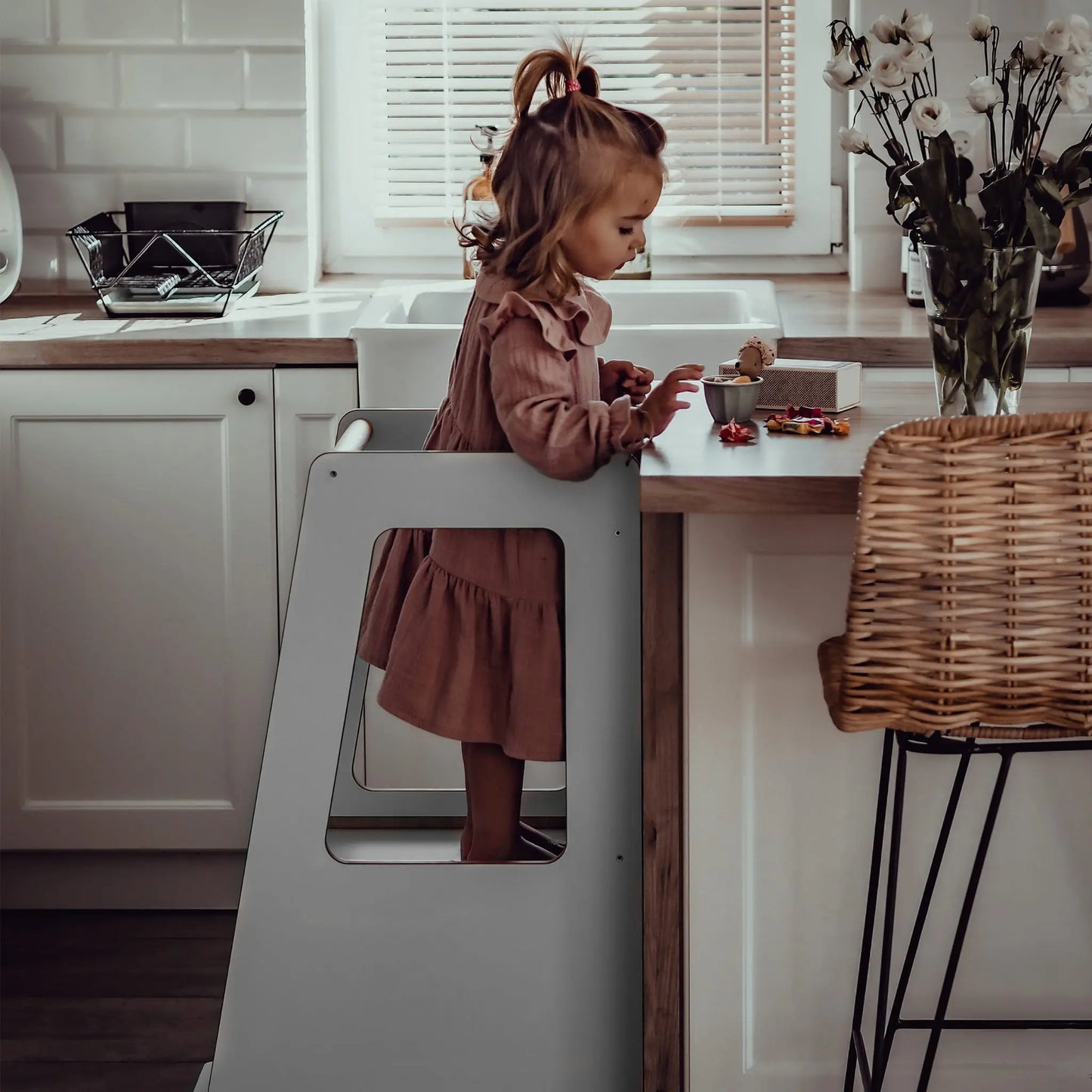 A child-friendly Plywood Kitchen Helper Scandi with adjustable platform heights for kitchen counter access. Birch plywood construction with melamine coating, embodying Scandinavian minimalism.