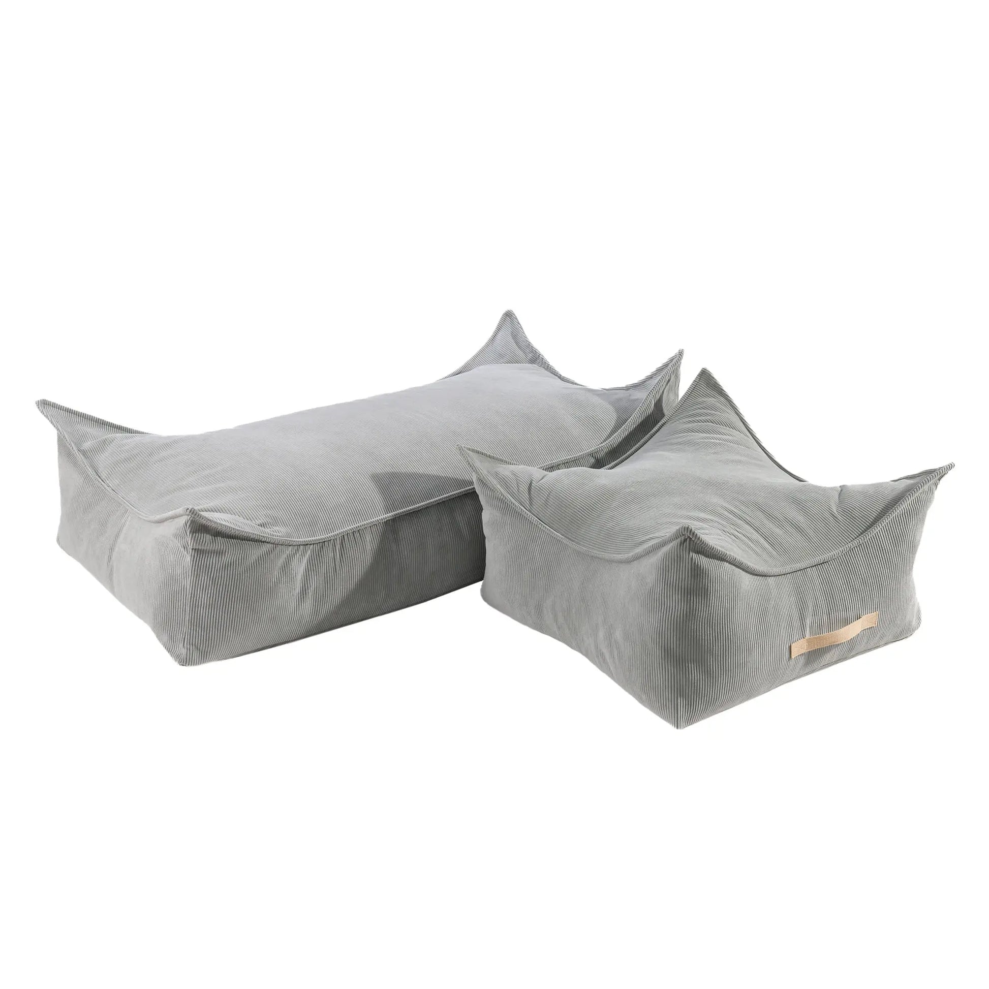 A close-up of a grey corduroy rectangular pouf for children, showcasing its durable material and innovative design with a separate filling insert. Dimensions: 120x60x35 cm.