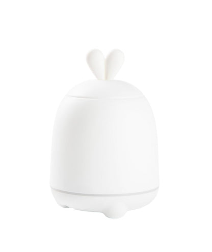 A white Rabbit Diffuser Lamp with bunny ears, emitting cool mist for air humidification and aromatherapy. LED light changes colors for night use. Water tank: 100ml. Dimensions: 15.1 x 10 x 10 cm.