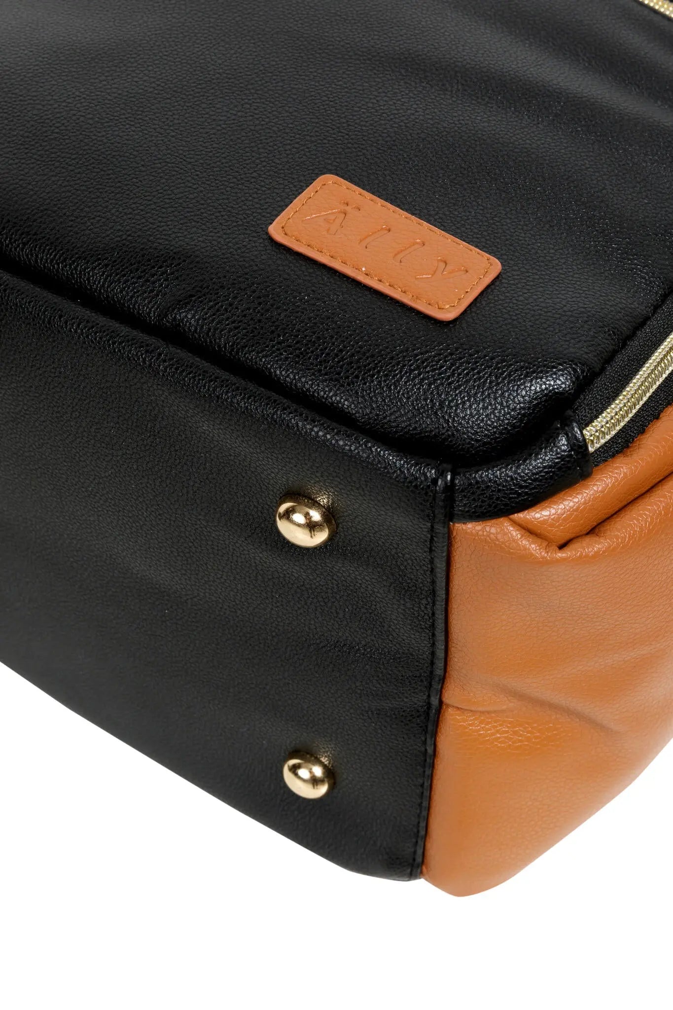 A close-up of a black coffee diaper bag with leather tag and zipper, featuring multiple pockets, stroller straps, and thermal lining for baby essentials.