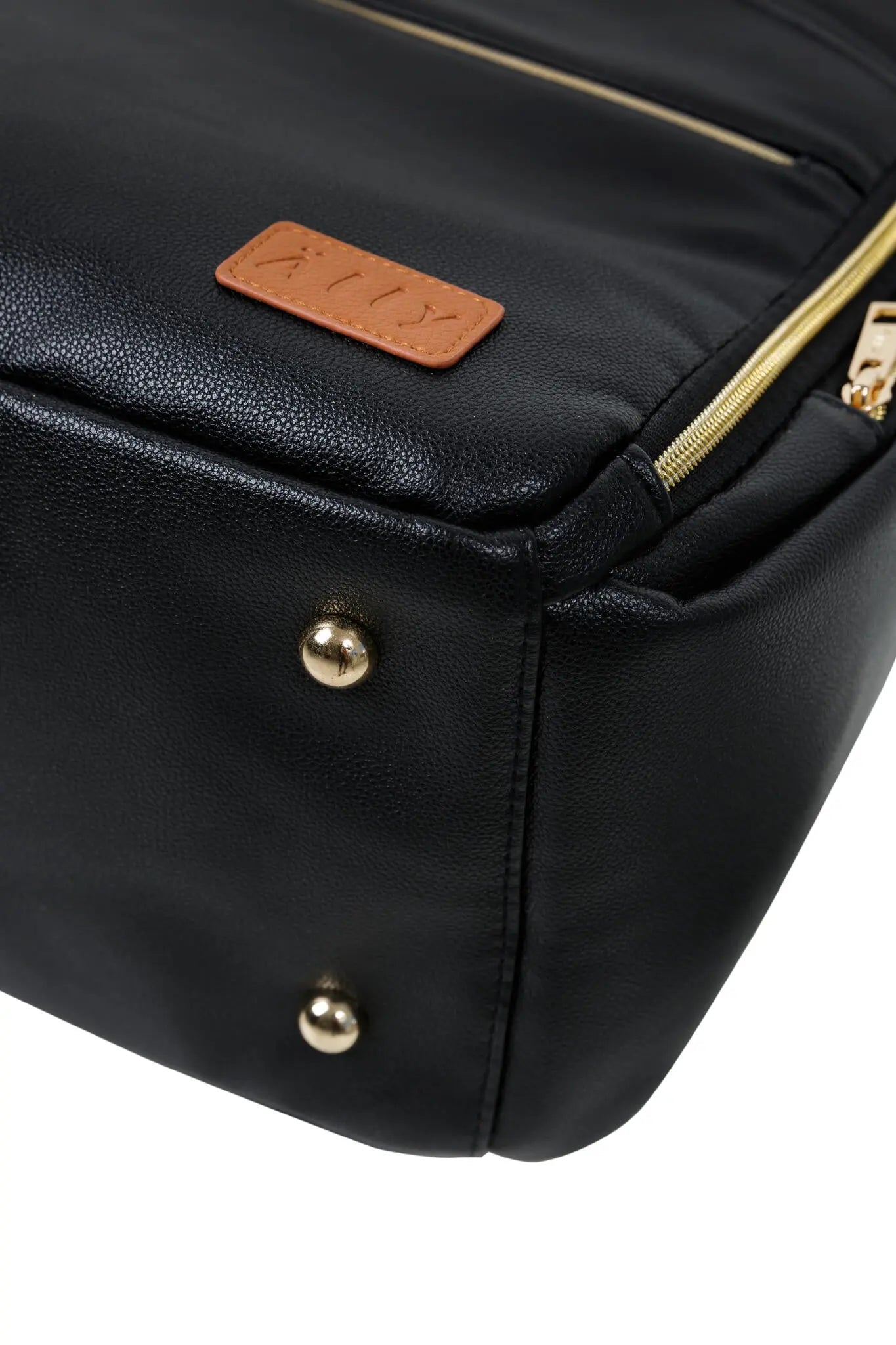 A close-up of a black leather diaper backpack with thoughtful compartments for easy organization and hands-free stroller straps. Stylish, lightweight, and versatile for on-the-go parents.