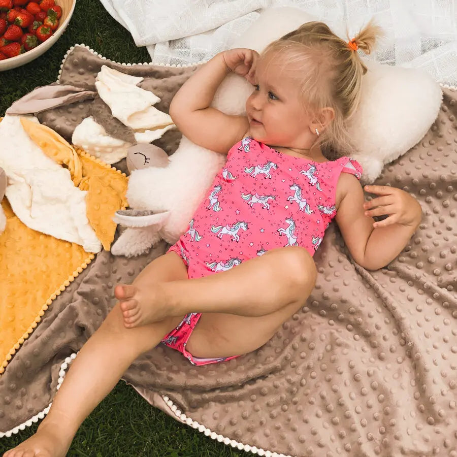 A toddler cuddles a Soft Toy-Pillow Alpaca in Cream, handmade from vegan fur. Versatile, hypoallergenic, and comforting for peaceful sleep. Ideal for kids aged 6 months+, perfect for travel or as a decorative cushion.